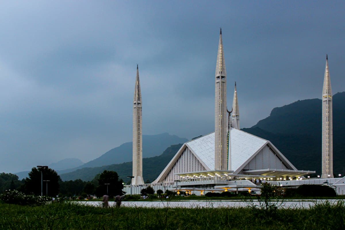 Faisal Mosque in Islamabad beneath the Margalla Hills